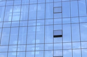 When choosing a glass curtain wall system, should you go with exposed framing or structural glazing